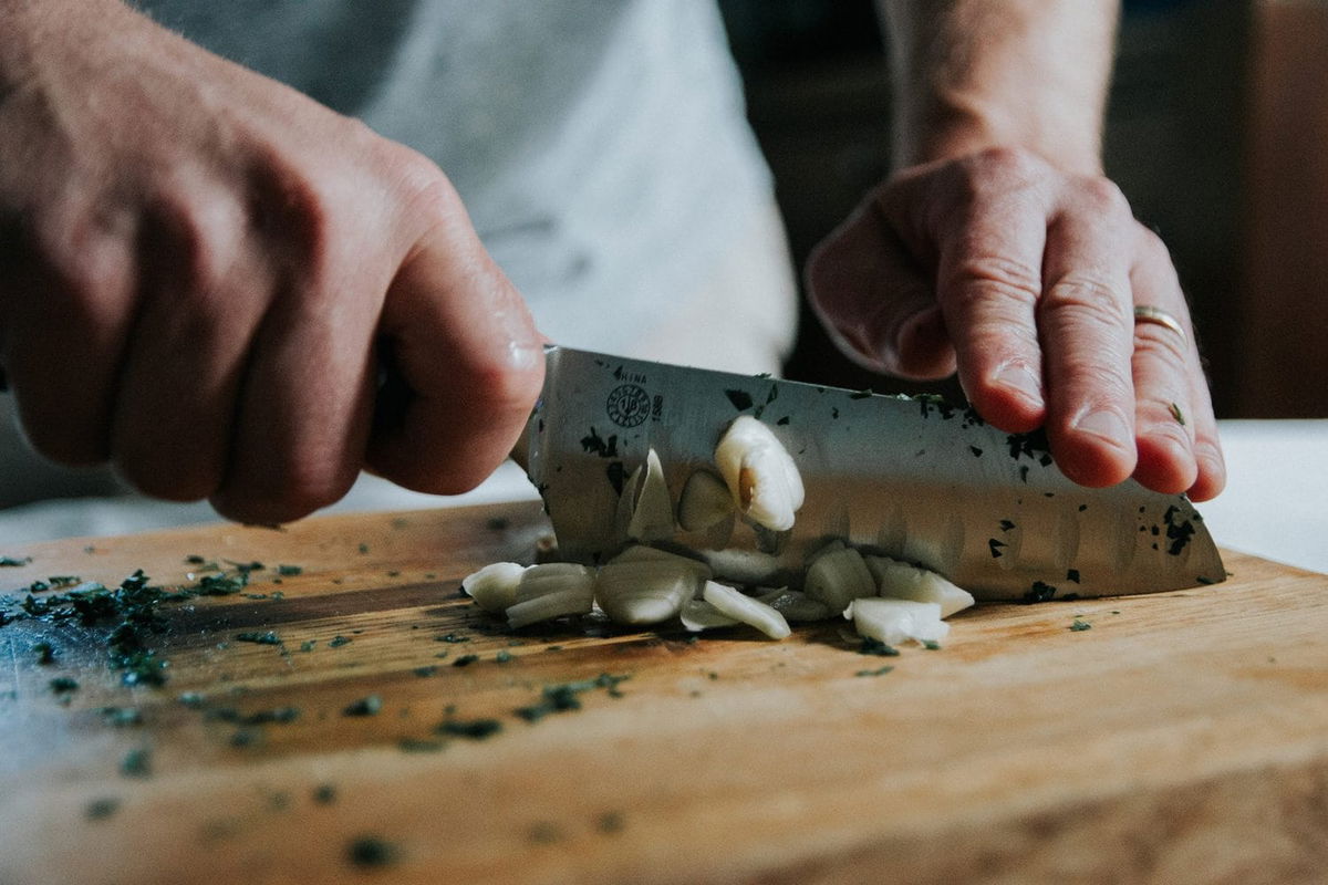 Chopping garlic.