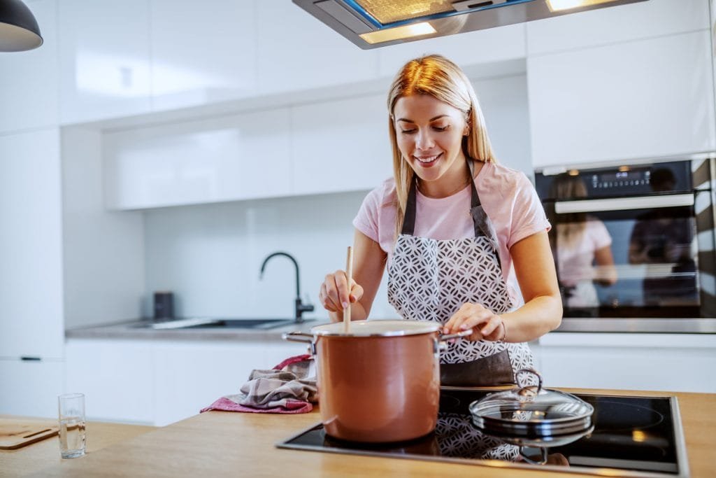 woman cooking with induction cookware