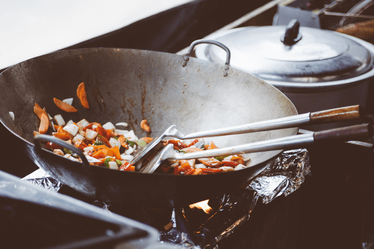 preparing meal in a carbon steel wok