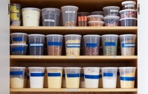 labeled deli containers in kitchen cabinet