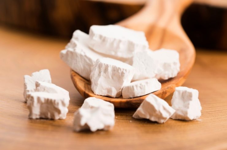 kuzu powder on a wooden spoon