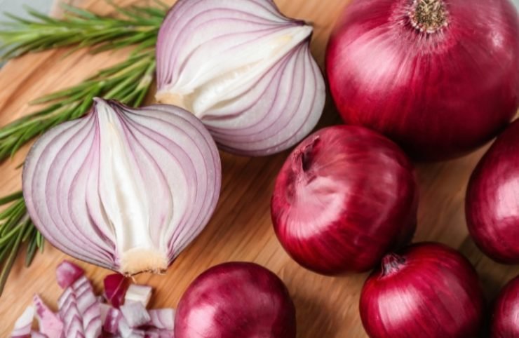 red onion on a wooden cutting board