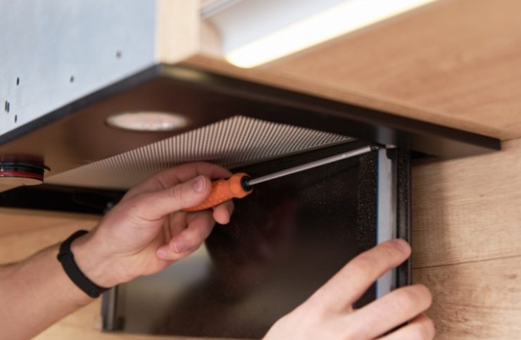 man installing a range hood