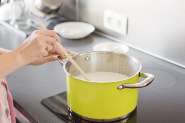 Woman Preparing cornstarch Sauce or Cream in a Pan.