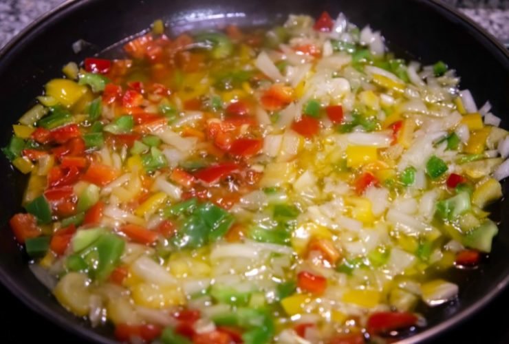 blanching vegetables in a black wok