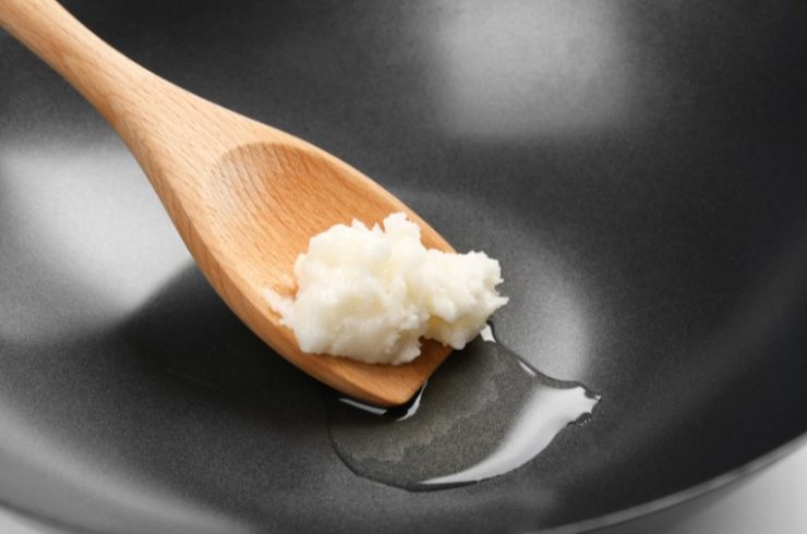 Spatula with Coconut Oil in Wok, Closeup