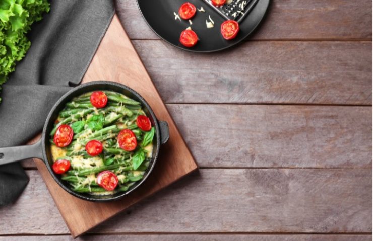 Frying Pan with Delicious Green Bean Casserole on Wooden Table