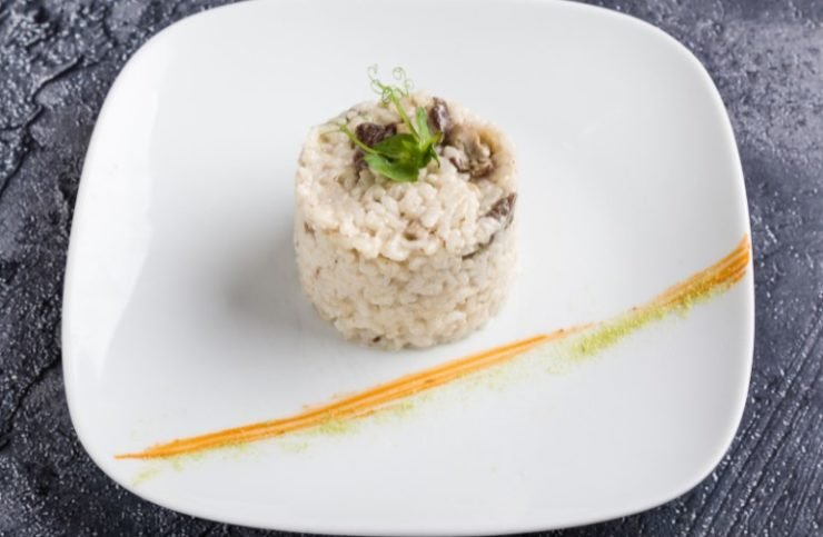 cooked tasty rice portion on white plate