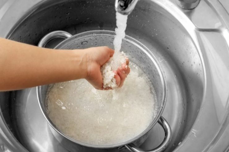 person rinsing rice