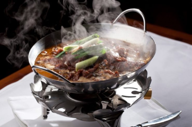 cooking meat and vegetables in a wok