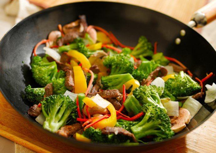 stir frying vegetables in a wok