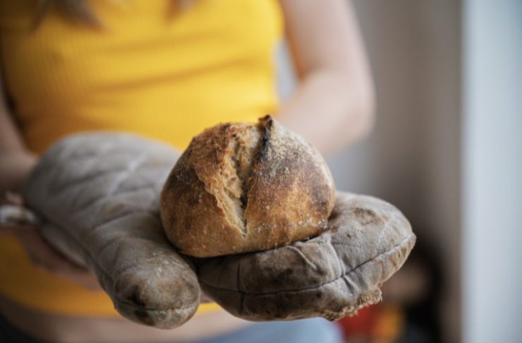 Woman Holding Freshly Baked Bread