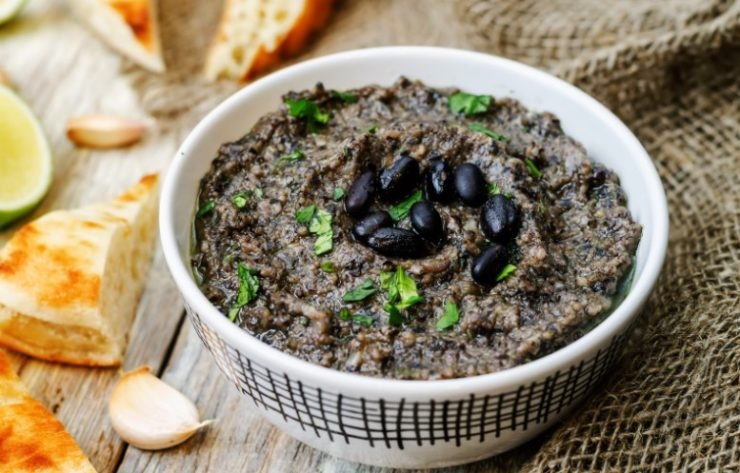 black bean hummus in a bowl on a wooden surface