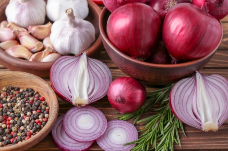 Bowls with Red Onion, Garlic and Spices on Table