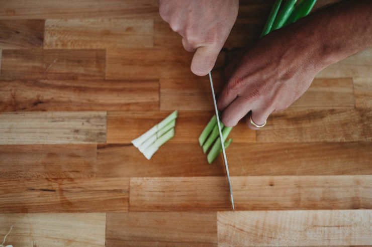 person cutting onion into bias