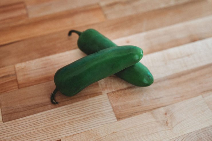 jalapenos on  a wooden surface