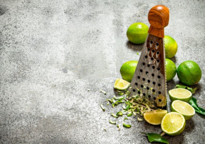 Grater with Fresh Limes .