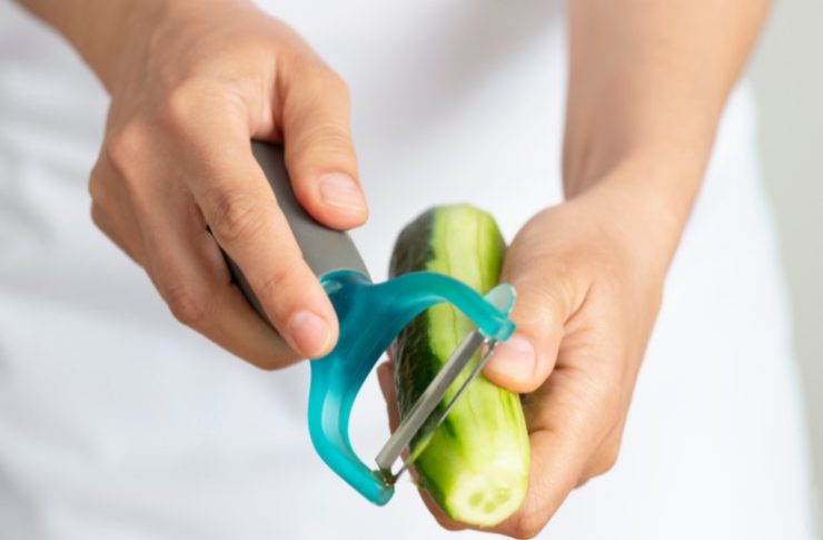 person Peeling Cucumber