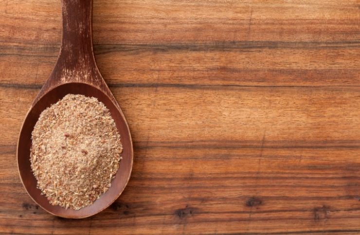 flax seeds on a wooden spoon