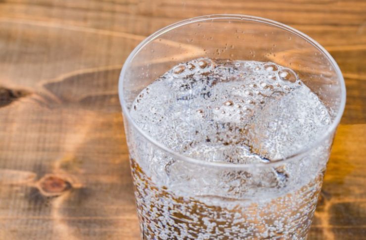 Carbonated water on wood grain background