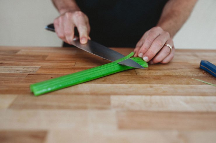 person peeling celery