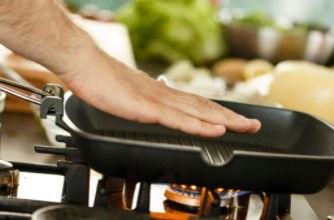 Man checking grill pan for heat