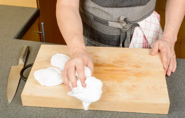 woman rubbbing board with towel