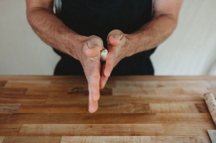 rubbing garlic between hands