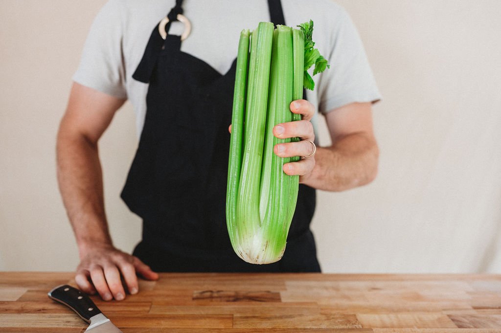 person holding celery