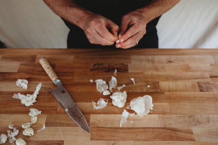 pinching garlic with hands