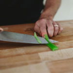 person peeling celery