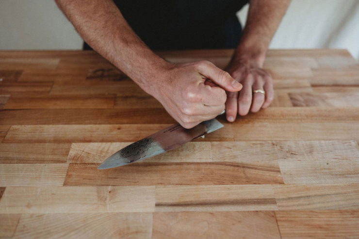 whacking garlic with knife