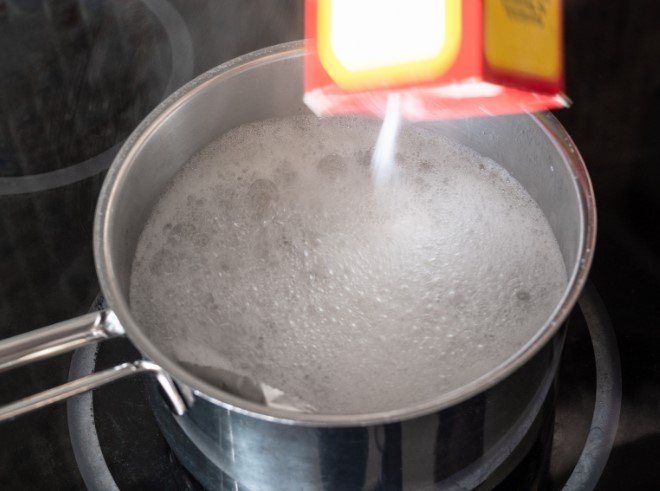 Pouring Baking Soda into Pot with Boiling Water