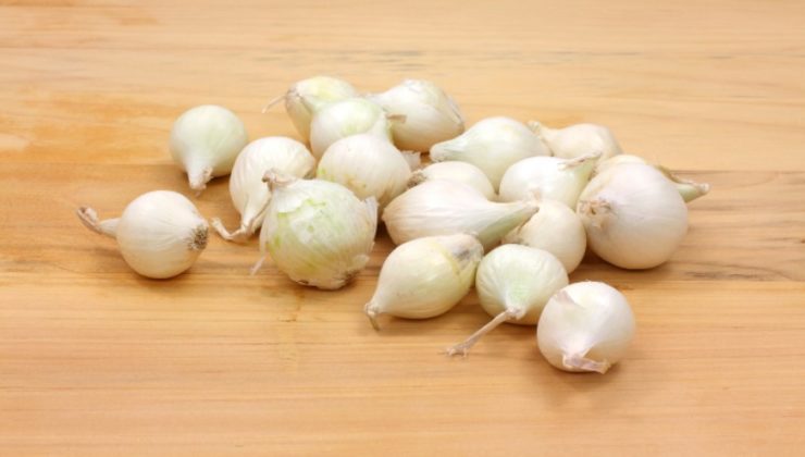 Boiling onions on wood cutting board