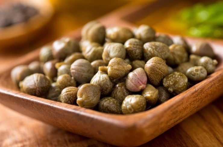 Capers in a wooden bowl