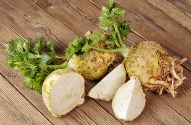 Fresh celery root on a wooden surface
