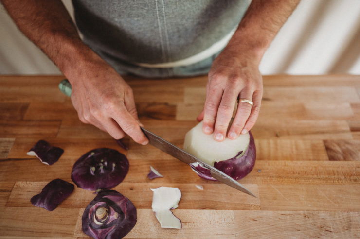 person peeling kohlrabi