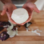 person holding peeled kohlrabi