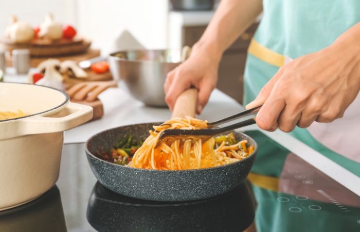 Woman Cooking Pasta on Electric Stove