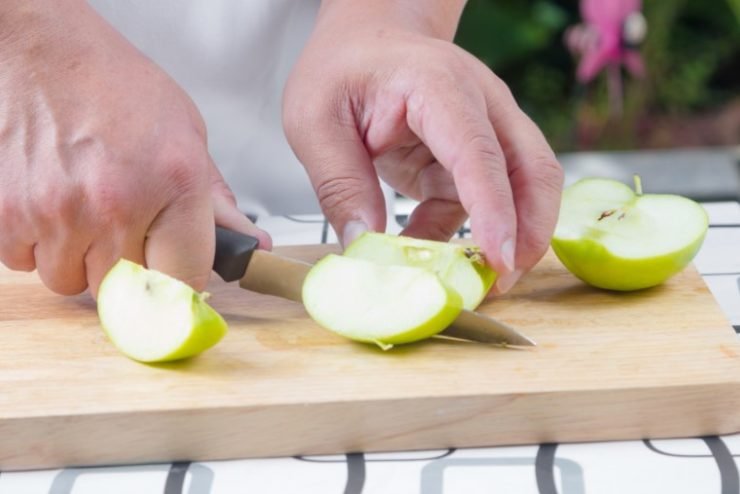 person cutting apples 