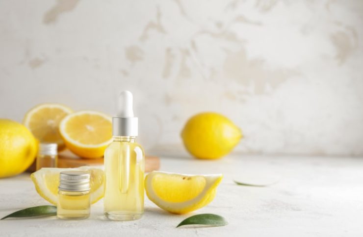 Bottles of Lemon Essential Oil on Table