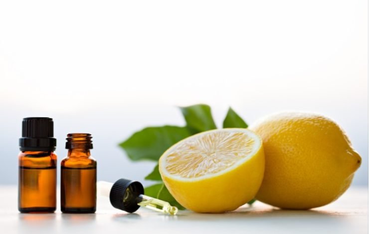 Lemon essential oils in bottles with lemon
