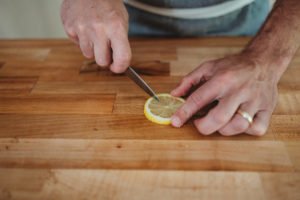 person slicing lemon slice