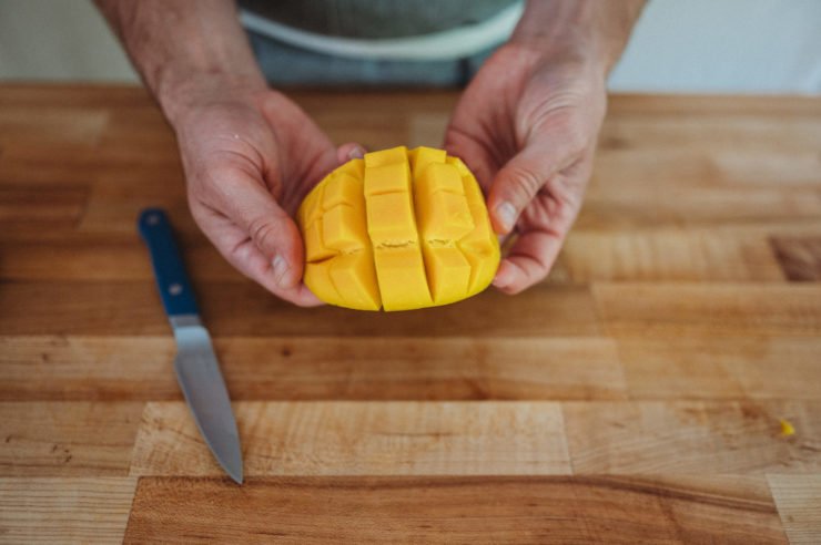 cut mango on a peel