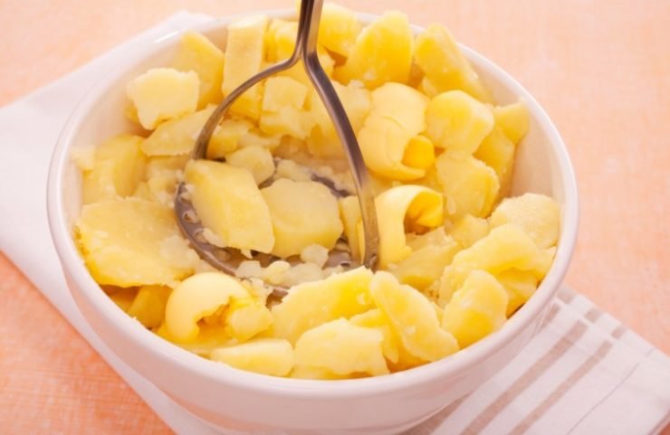 Mashing Potato with a potato masher