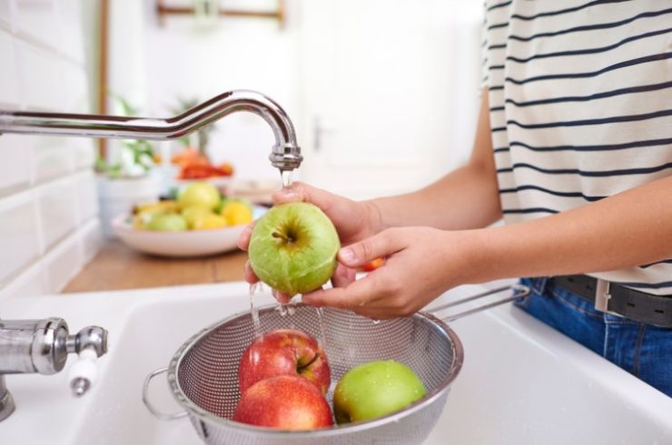 person Washing Fresh Apples