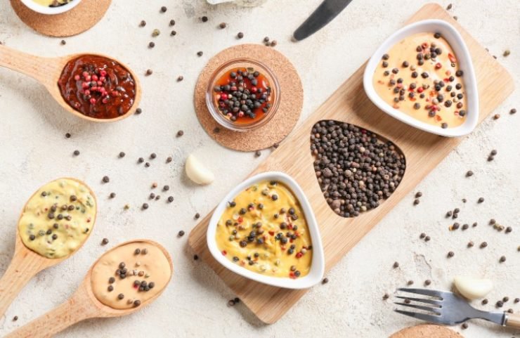 Composition with Different Sauces and Peppercorns on Light Background 