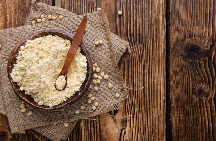 flour in a wooden bowl on a wooden table