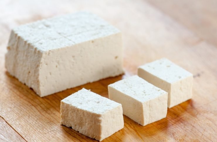 Block of Extra Firm Tofu on Wood Cutting Board