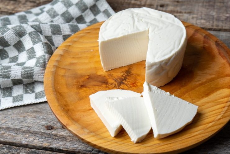 Fresh and tasty mexican panela cheese on wood background